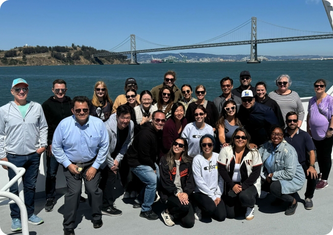 a group of coworkers from different races taking a group photo
